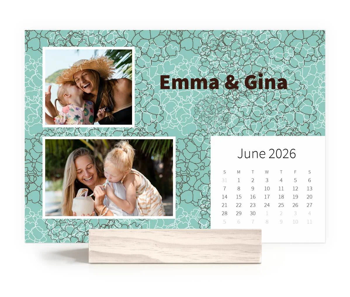 Desk calendar with teal floral background, photos of a mother and child labeled “Emma & Gina,” and June 2026 calendar grid.