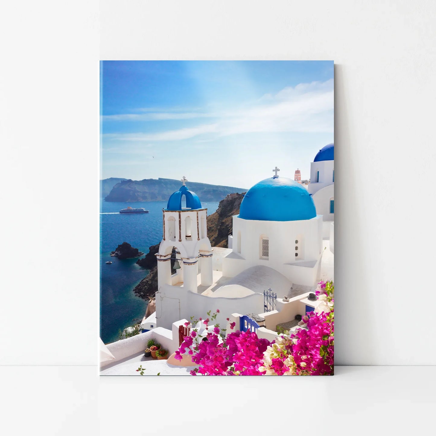 Acrylic wall print featuring white buildings with blue domes overlooking the ocean, with coastal cliffs and water in the background.