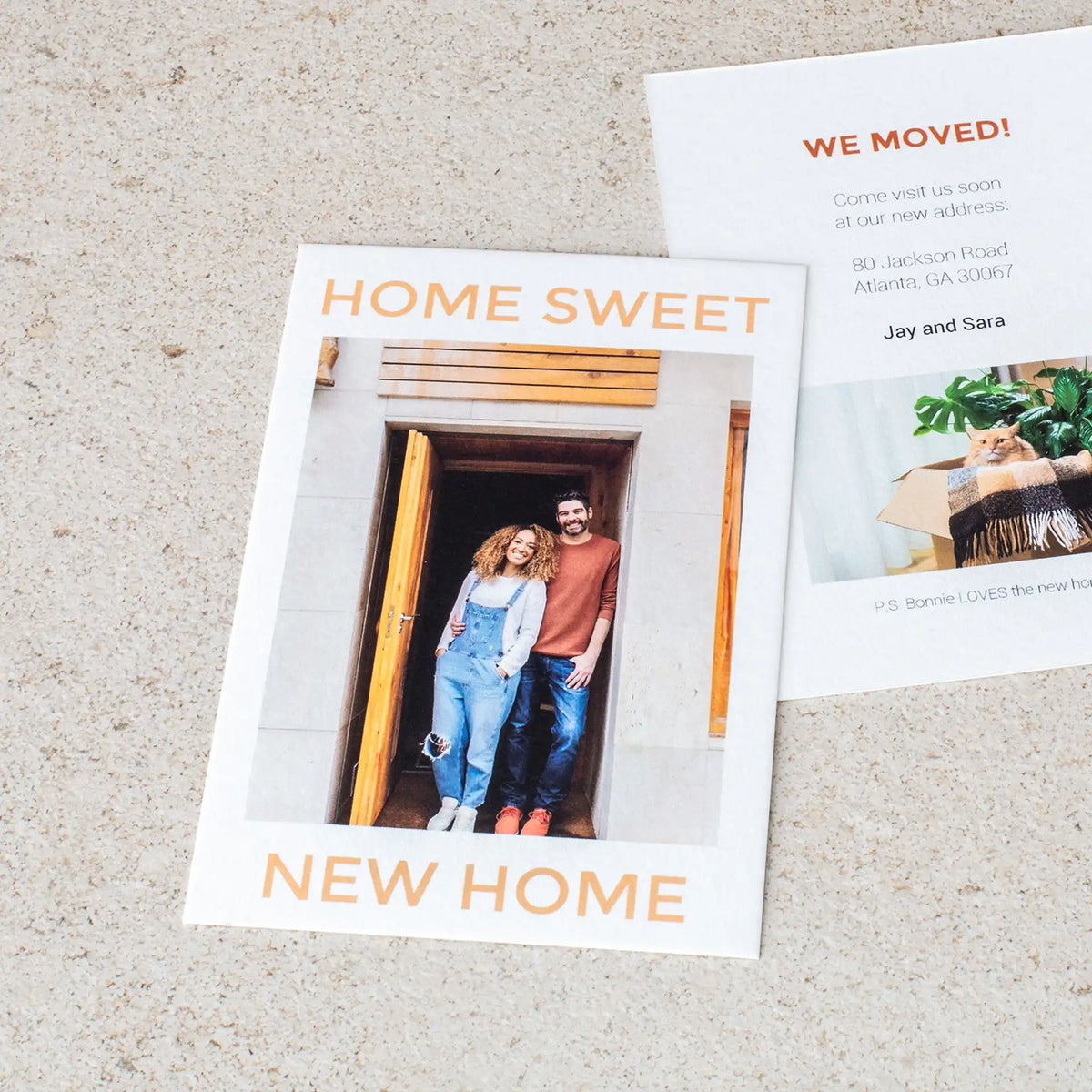 Two flat cards announcing a new home, showing a couple standing in a doorway with 'Home Sweet New Home' and a new address.