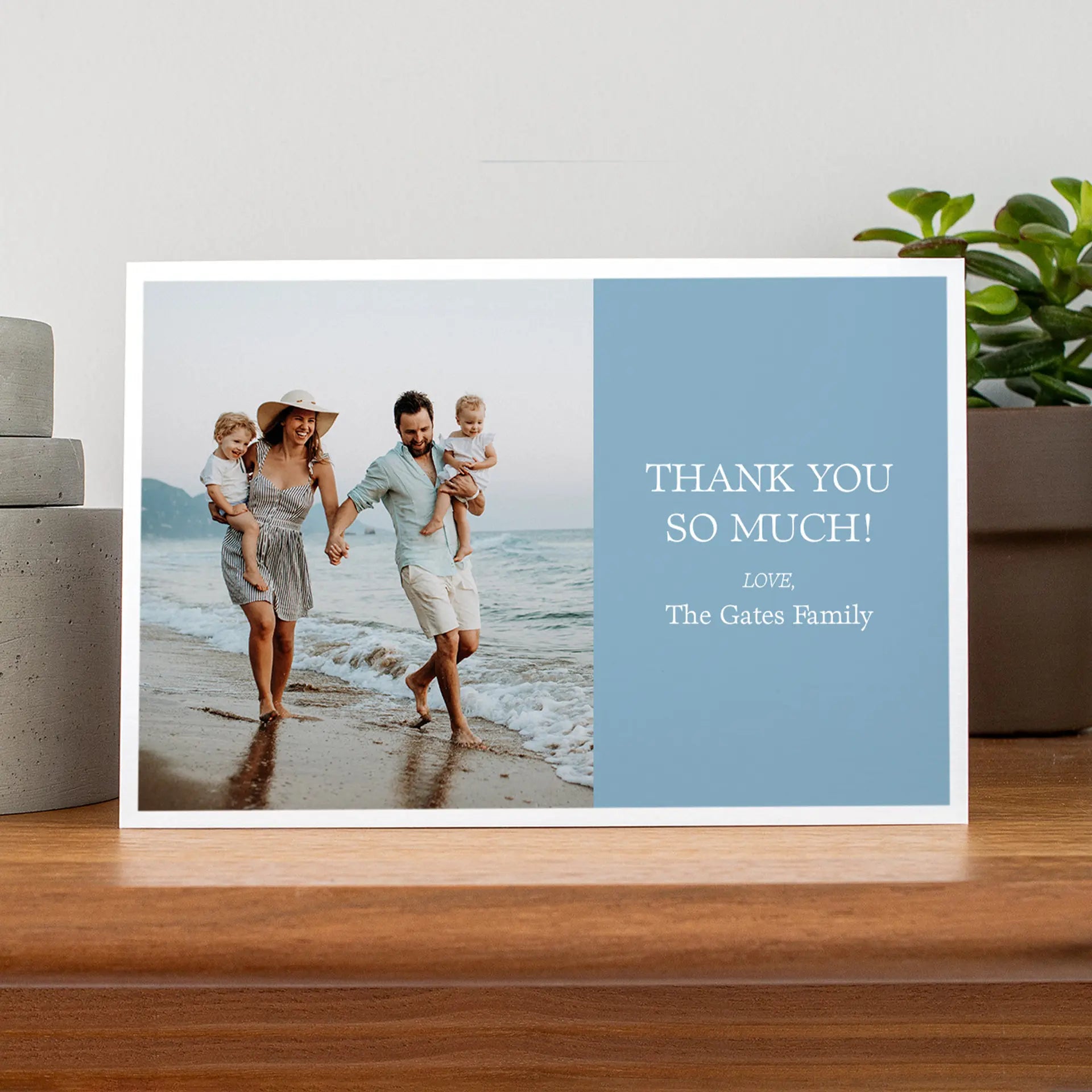 Folded thank you photo card displaying family walking along beach shoreline with blue text panel reading “Thank You So Much.”