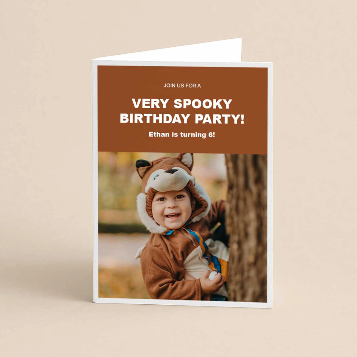 Folded card birthday invitation reading 'Very Spooky Birthday Party, Ethan is turning 6,' featuring a boy in a fox costume.