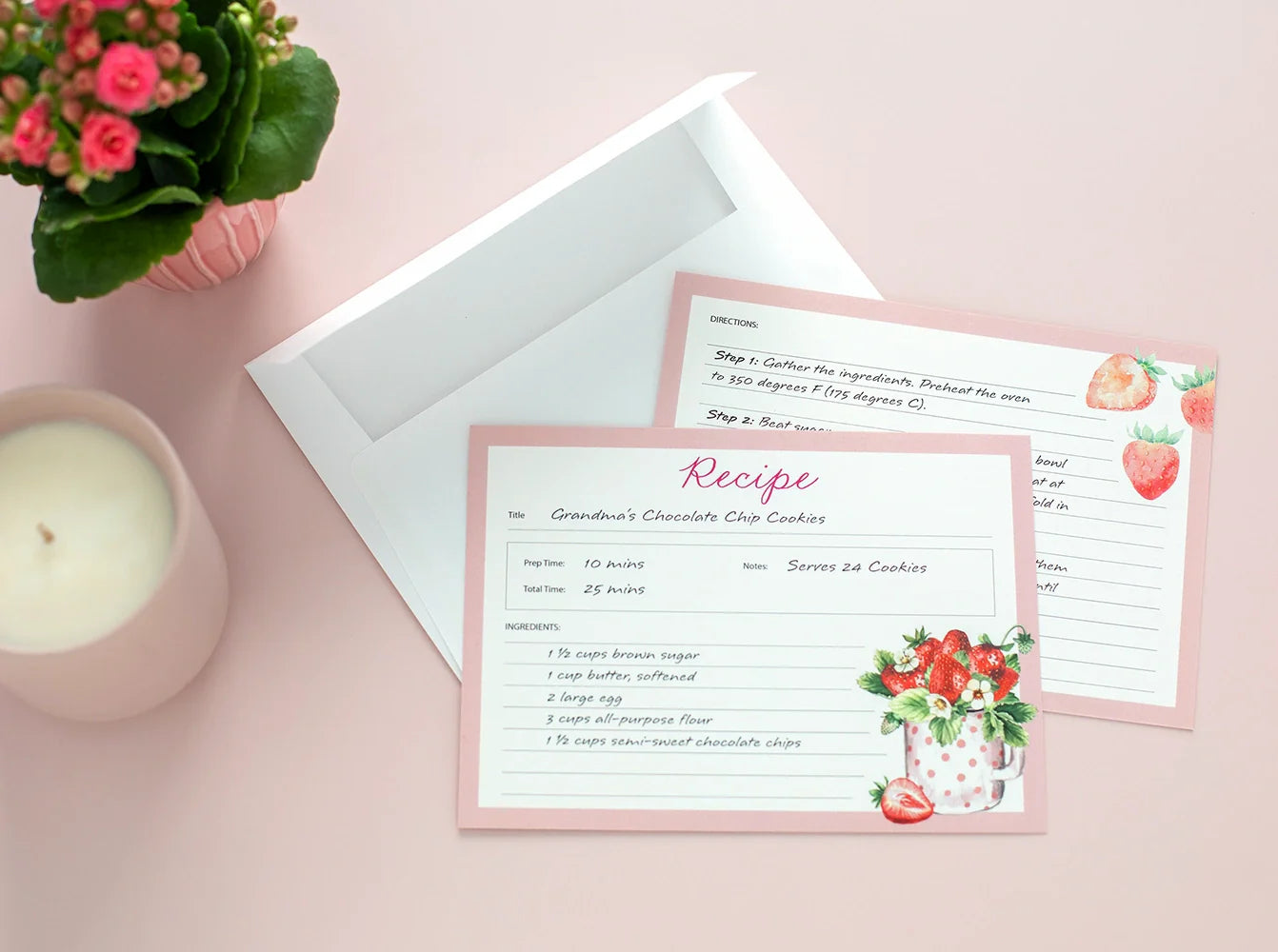 Flat recipe card with handwritten cookie recipe and decorative strawberry design, shown with envelope.