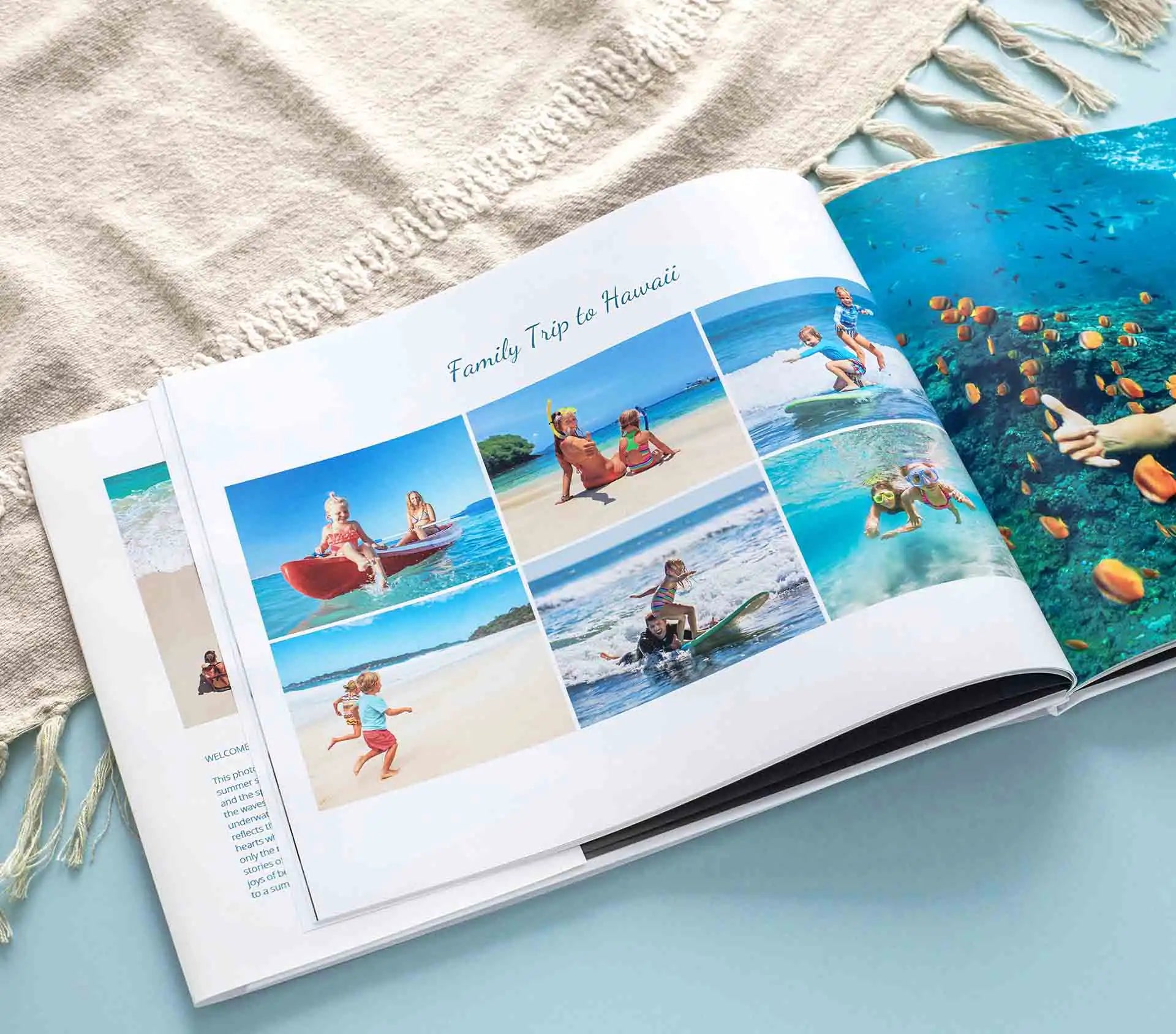 Hardcover layflat photo book open to beach vacation spread with multiple family photos arranged in grid layout on thick matte pages.