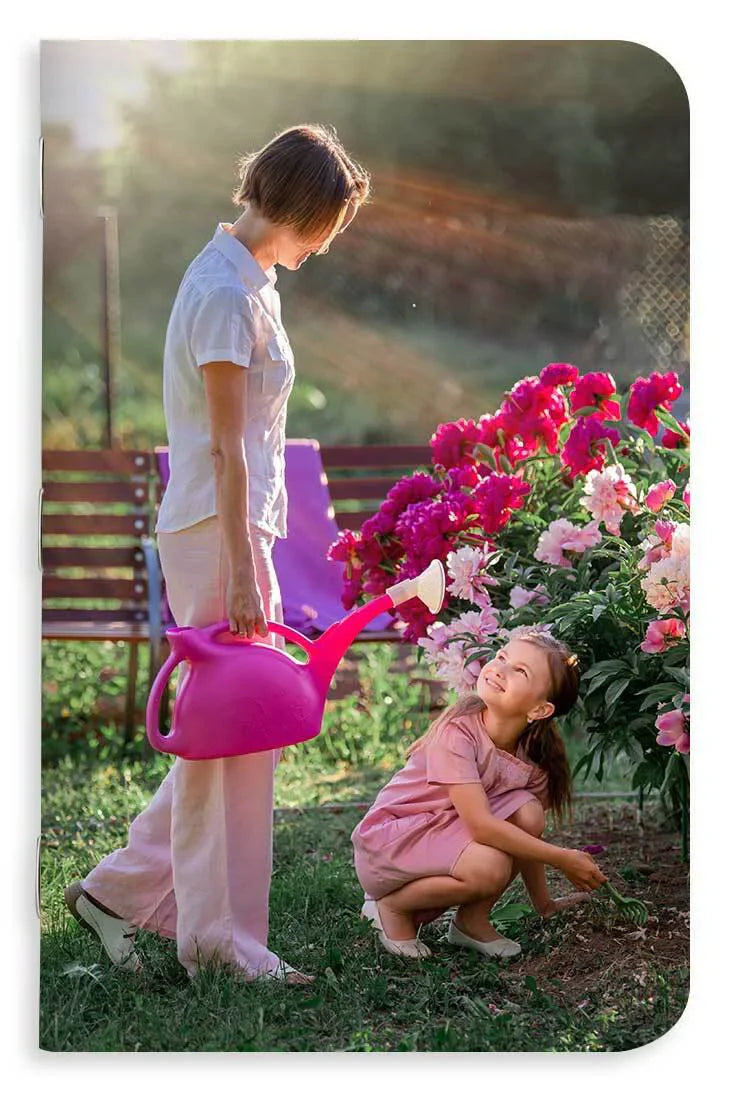 Memo book cover design with a woman and child with a pink watering can in a garden setting