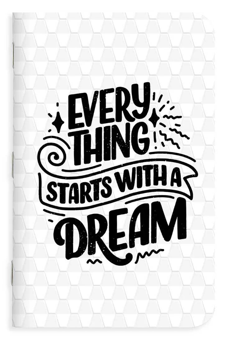 Motivational quote 'Everything starts with a dream' on a memo book cover