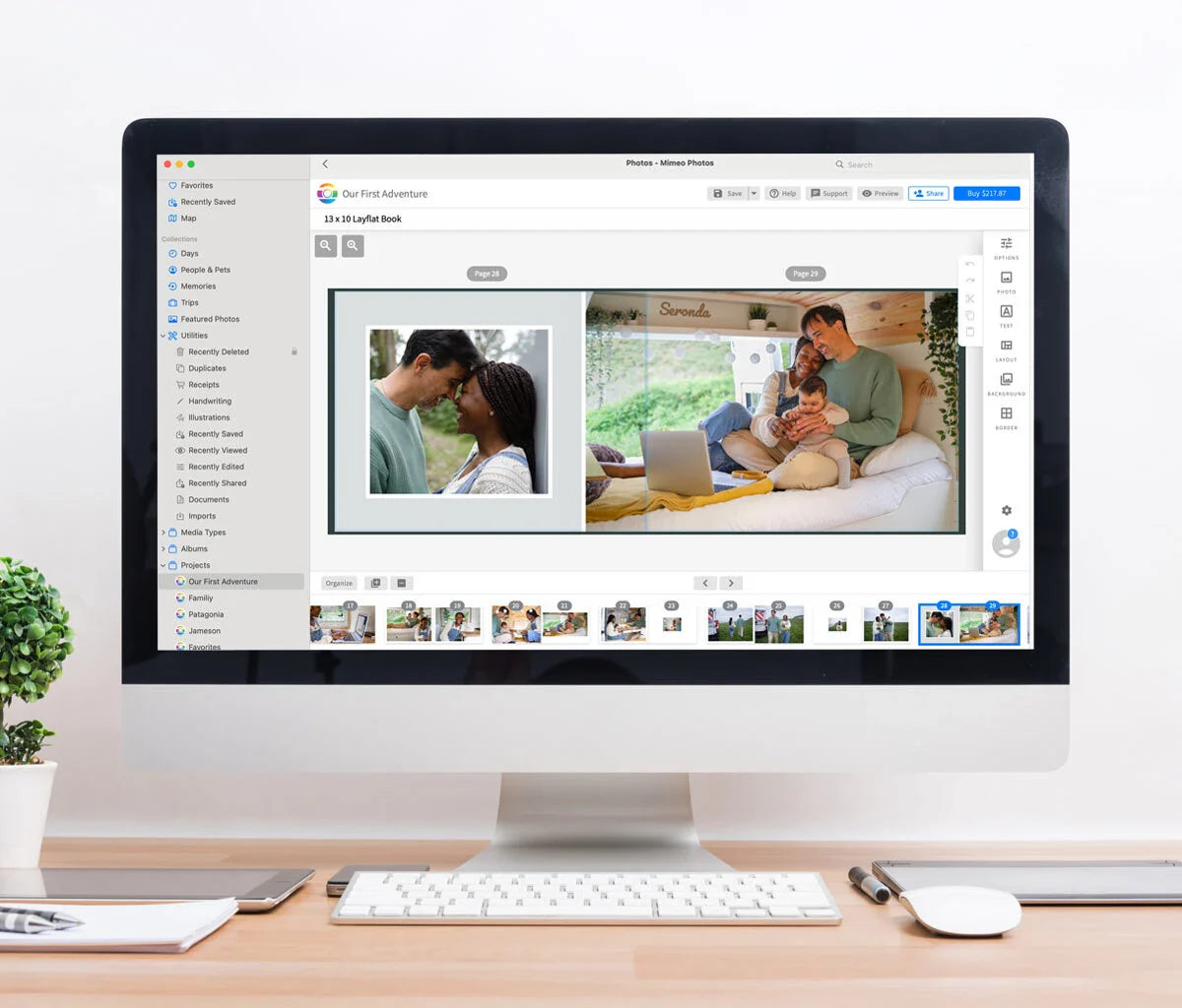 Desktop computer displaying a layflat photo book editor with a family lifestyle spread and page organization panel on the left.