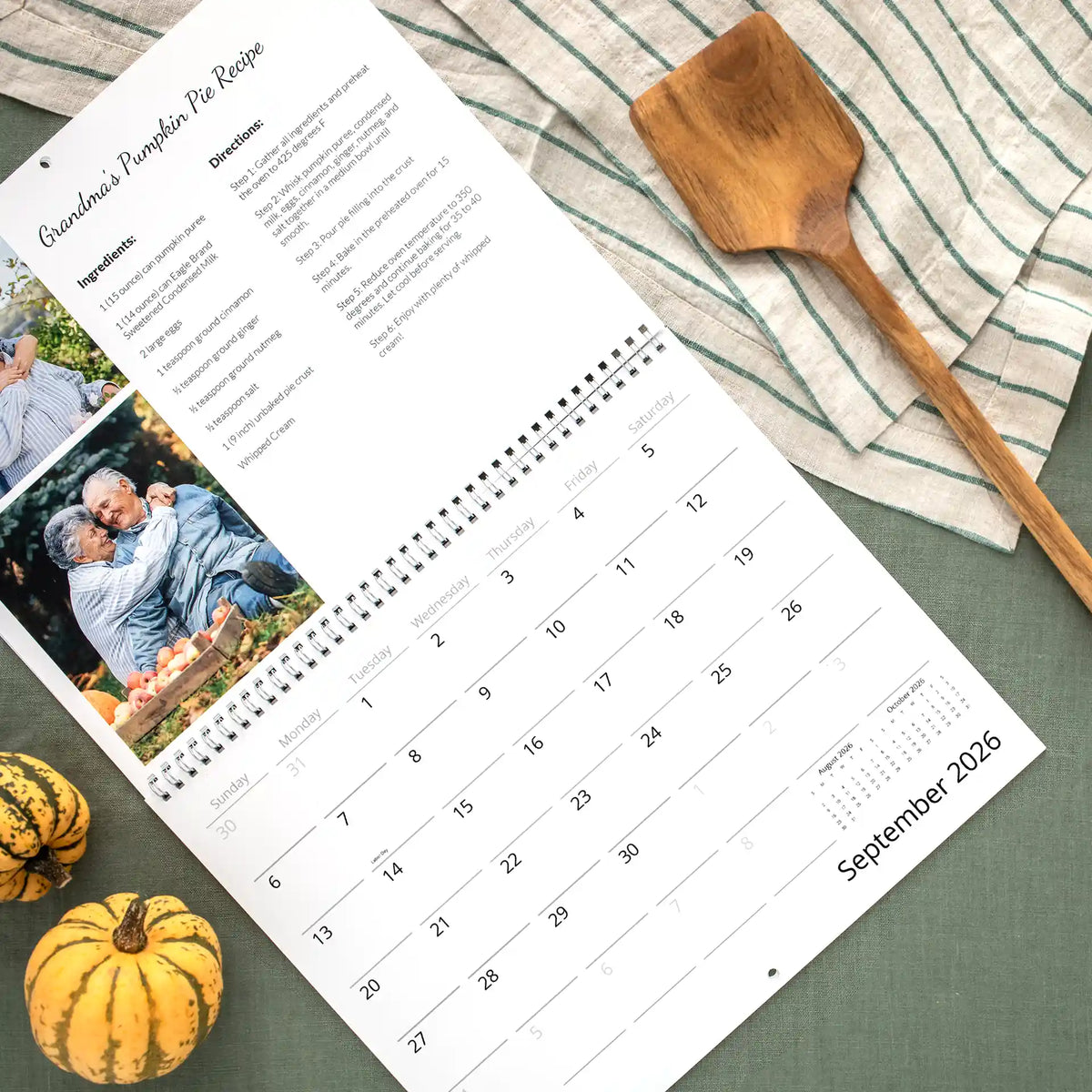 September 2026 wall calendar page featuring Grandma's Pumpkin Pie recipe and a photo of an older couple at an apple orchard, above the date grid.