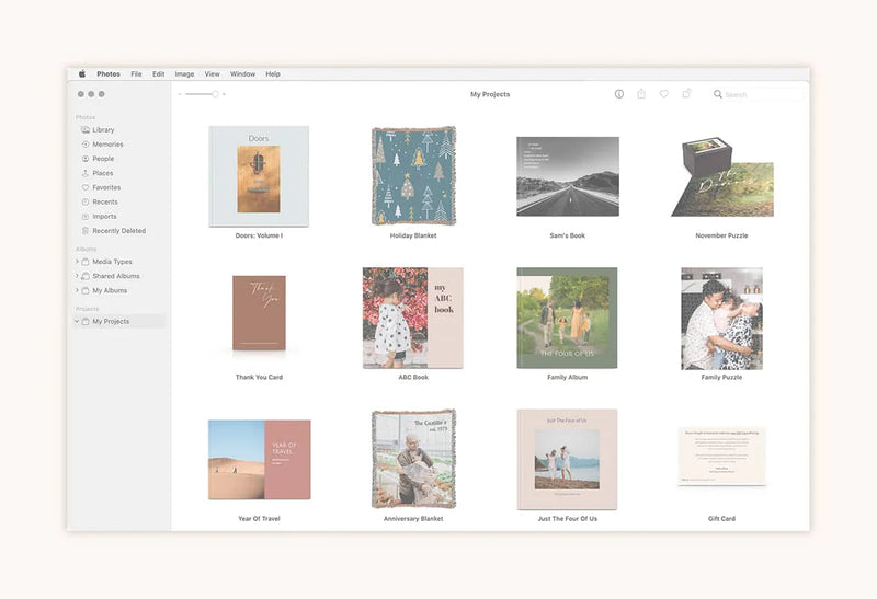 Computer screen displaying a photo project library interface with albums, photo books, puzzles, and cards organized in a grid.