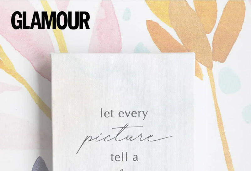 Minimalist canvas print with the phrase “let every picture tell a story” placed on a colorful patterned background, with the Glamour logo.