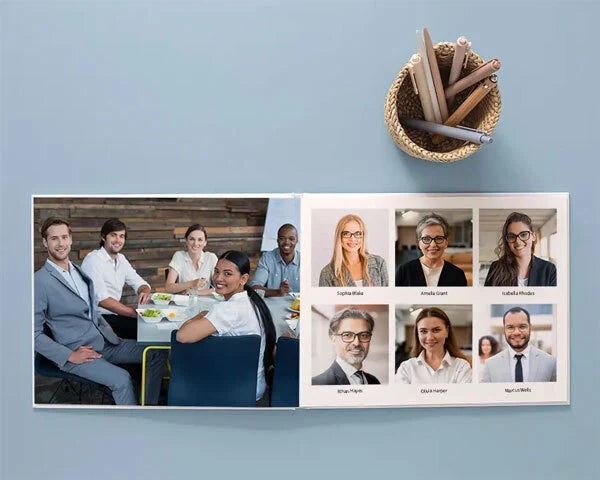 Photo book open to team profile layout with group meeting photo on one page and employee headshots with names on the opposite page.