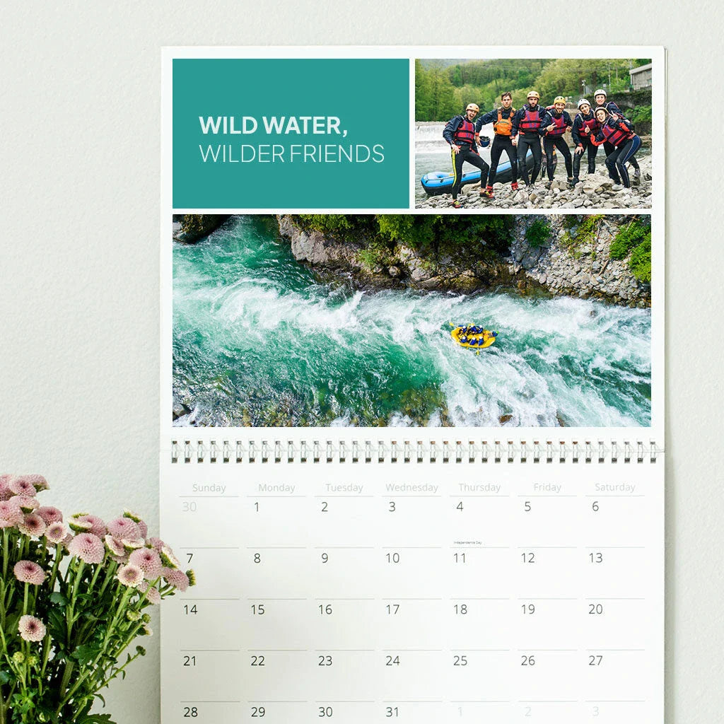 Wall calendar with rafting-themed photo collage and the headline “Wild Water, Wilder Friends” above a monthly date grid.