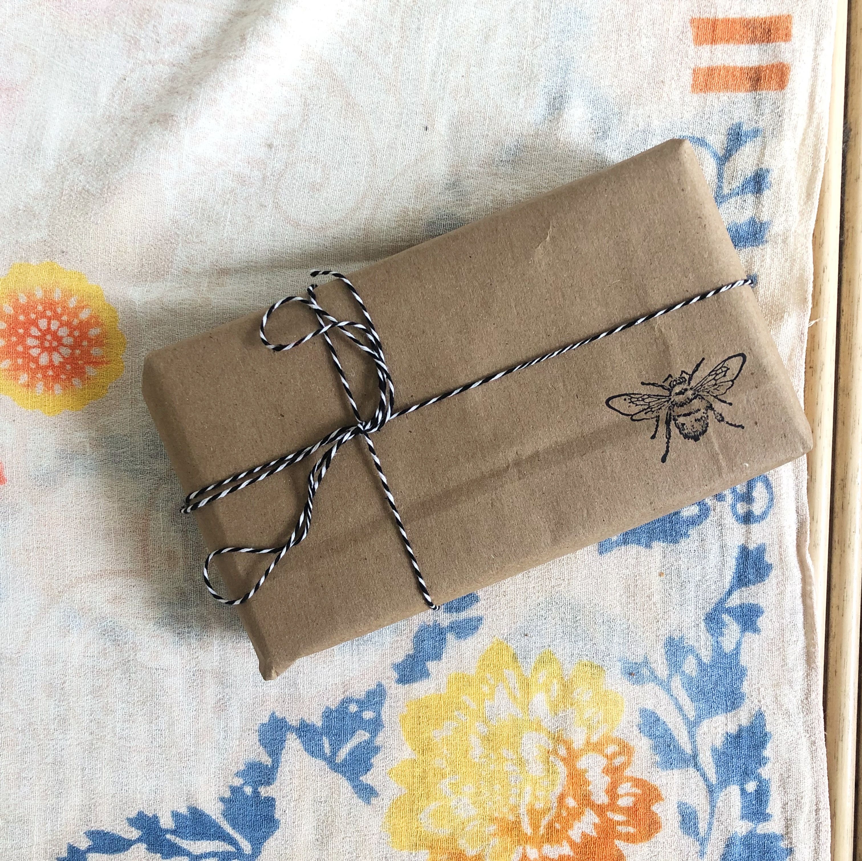 Recycle your paper bags and add a custom stamp to make a statement in your gift wrapping