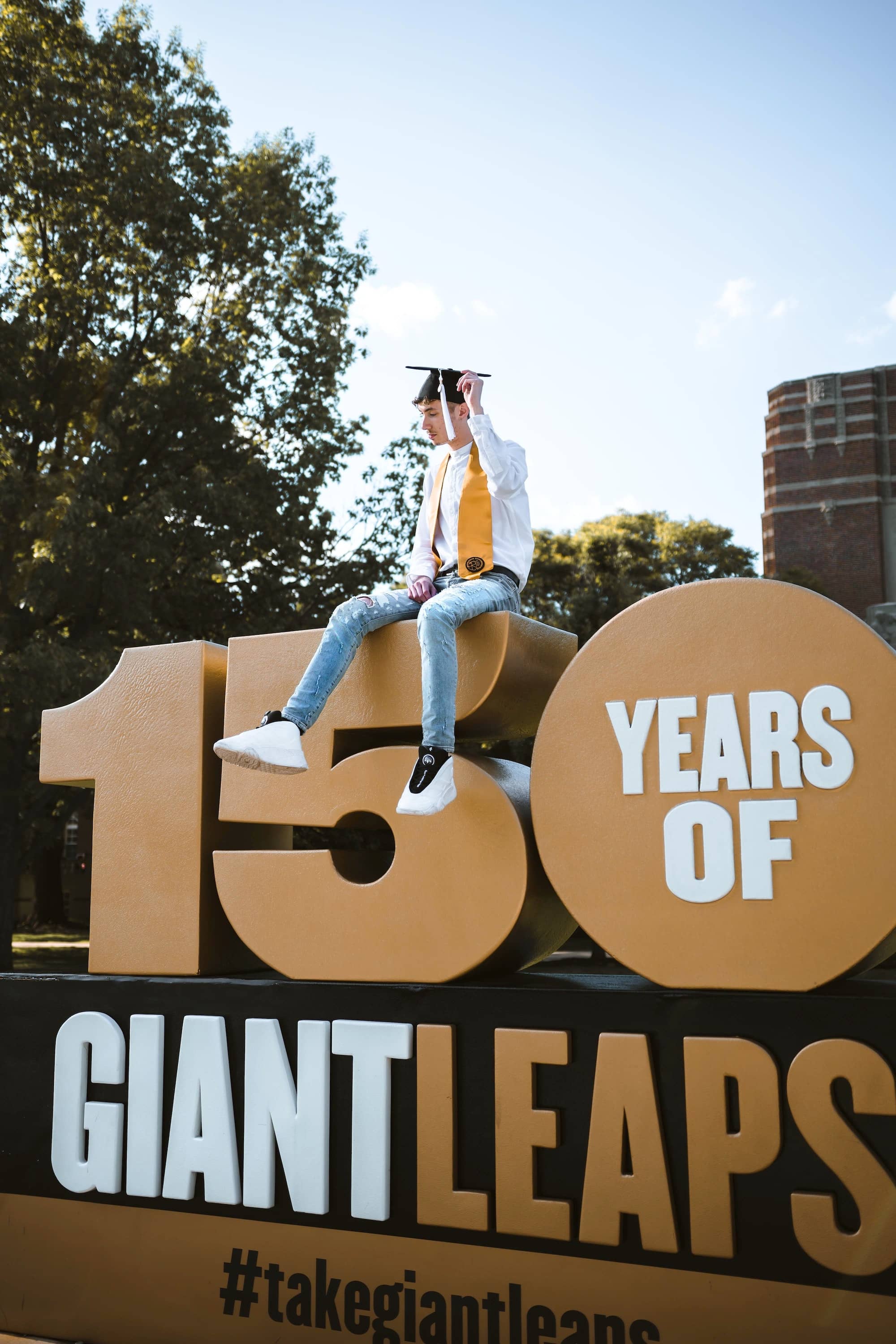 Use the campus or local backdrops for a graduation card announcement