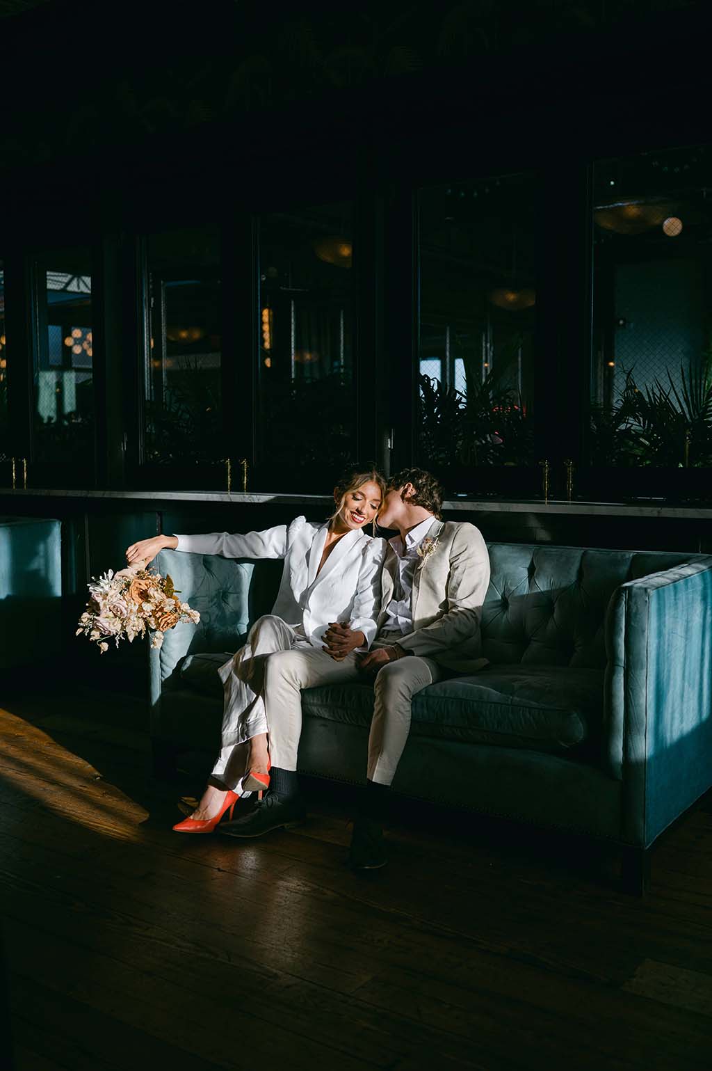 Couple sitting in booth at restaurant for engagement photos