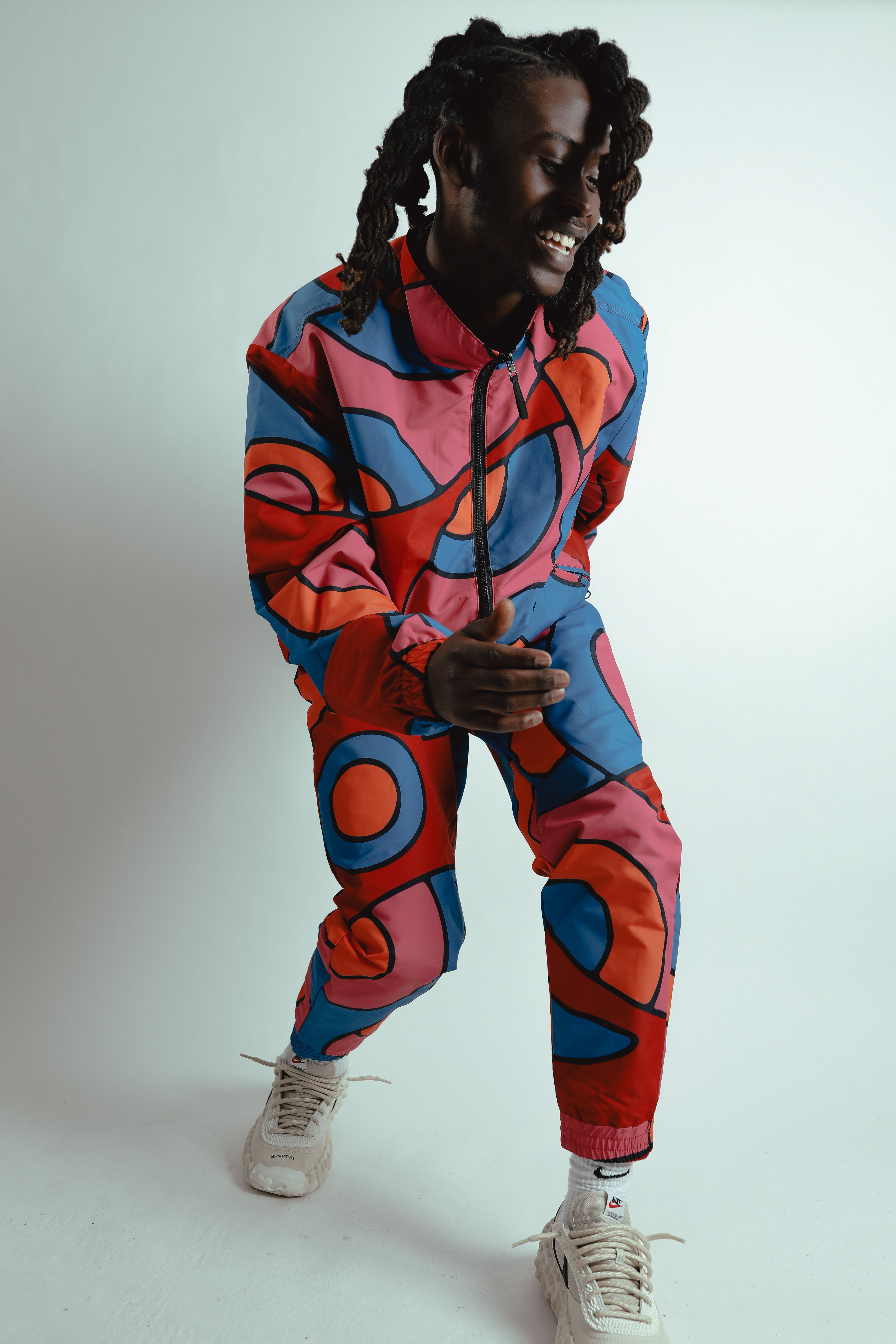 person dancing in colorful tracksuit