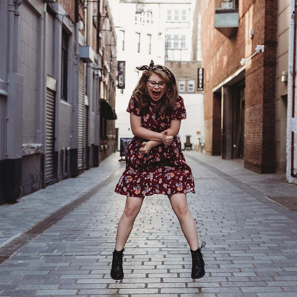 Girl jumping in the air on the street