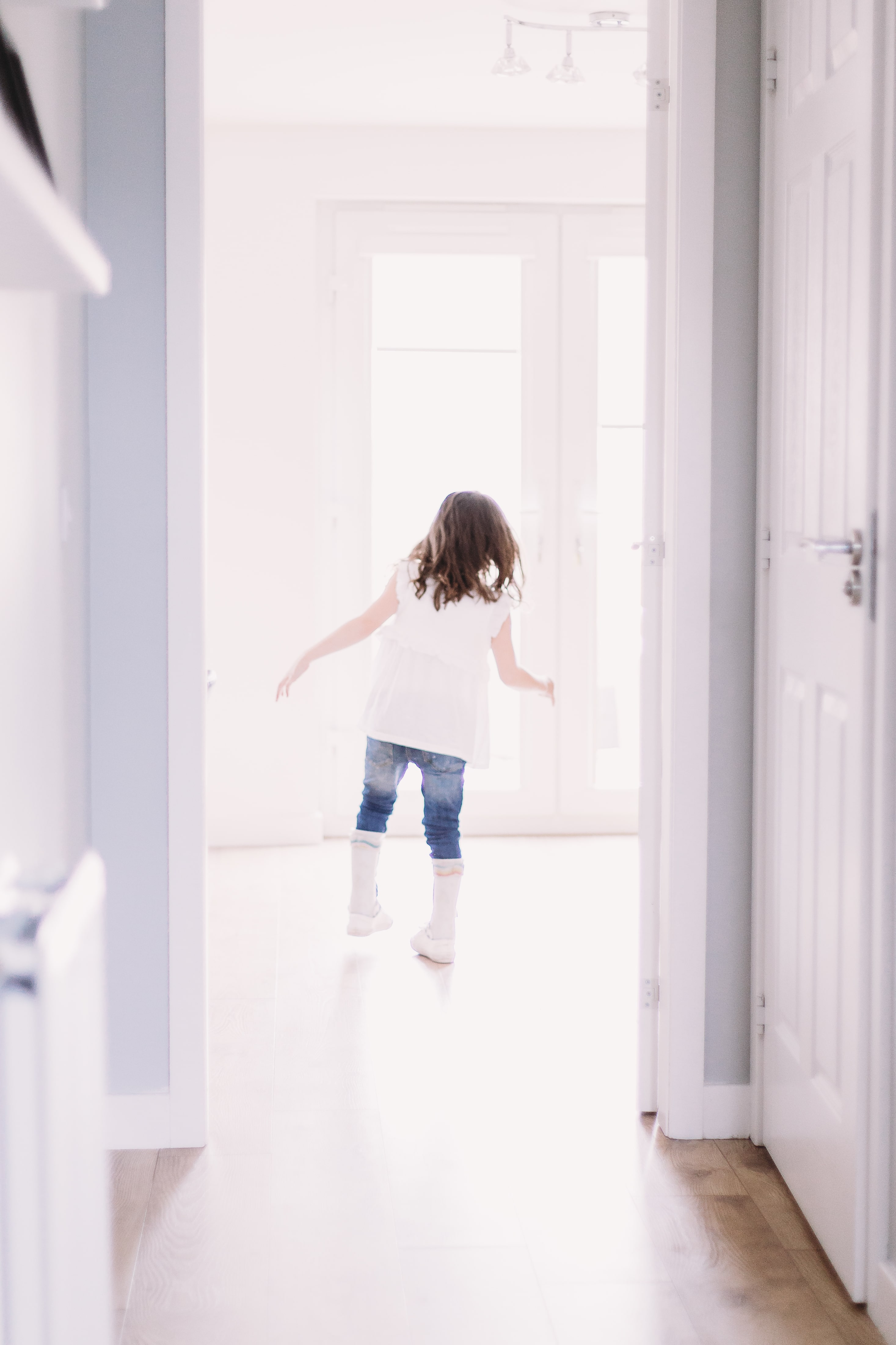 little girl walking out of room