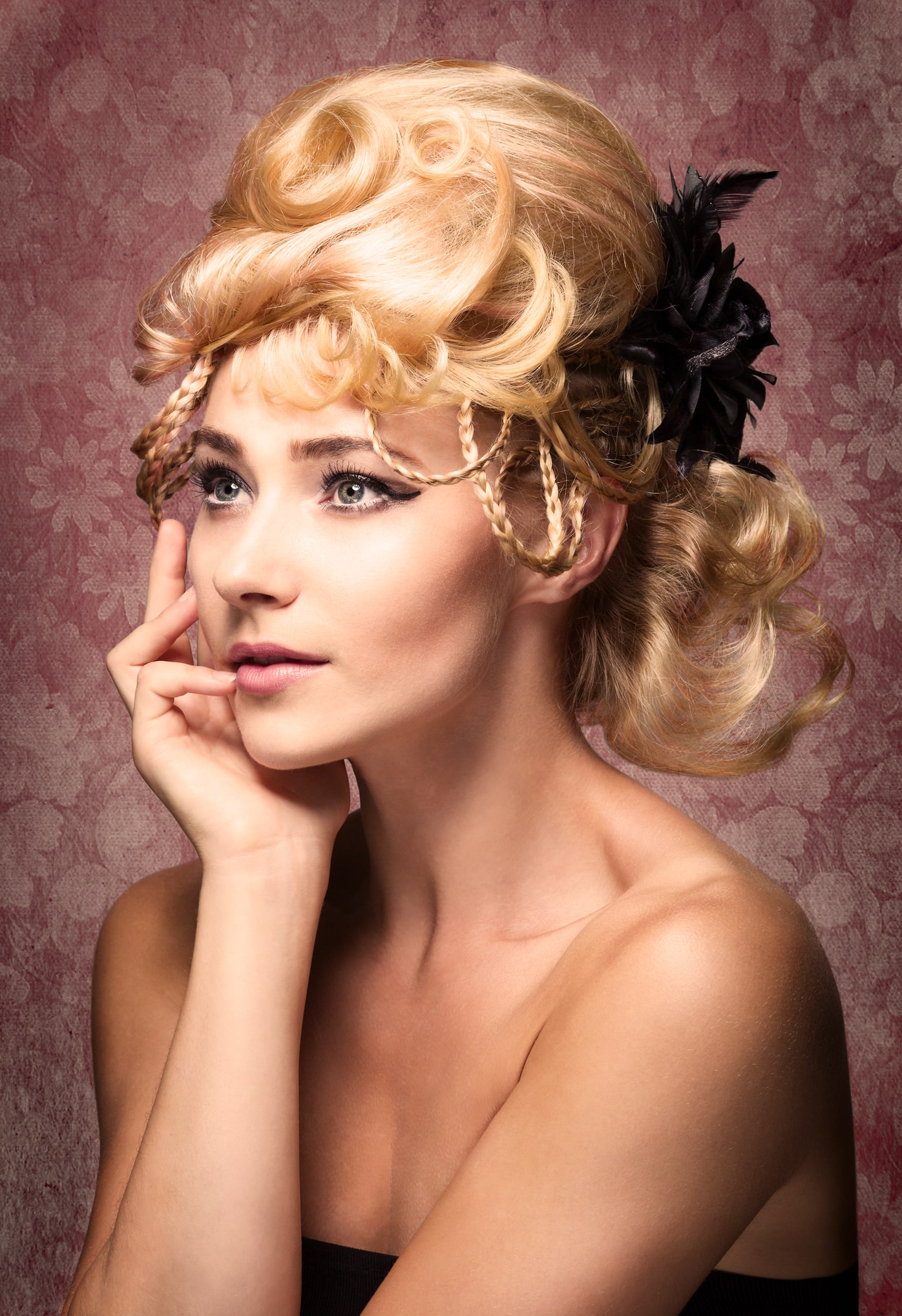 portrait of blonde woman with black headpiece