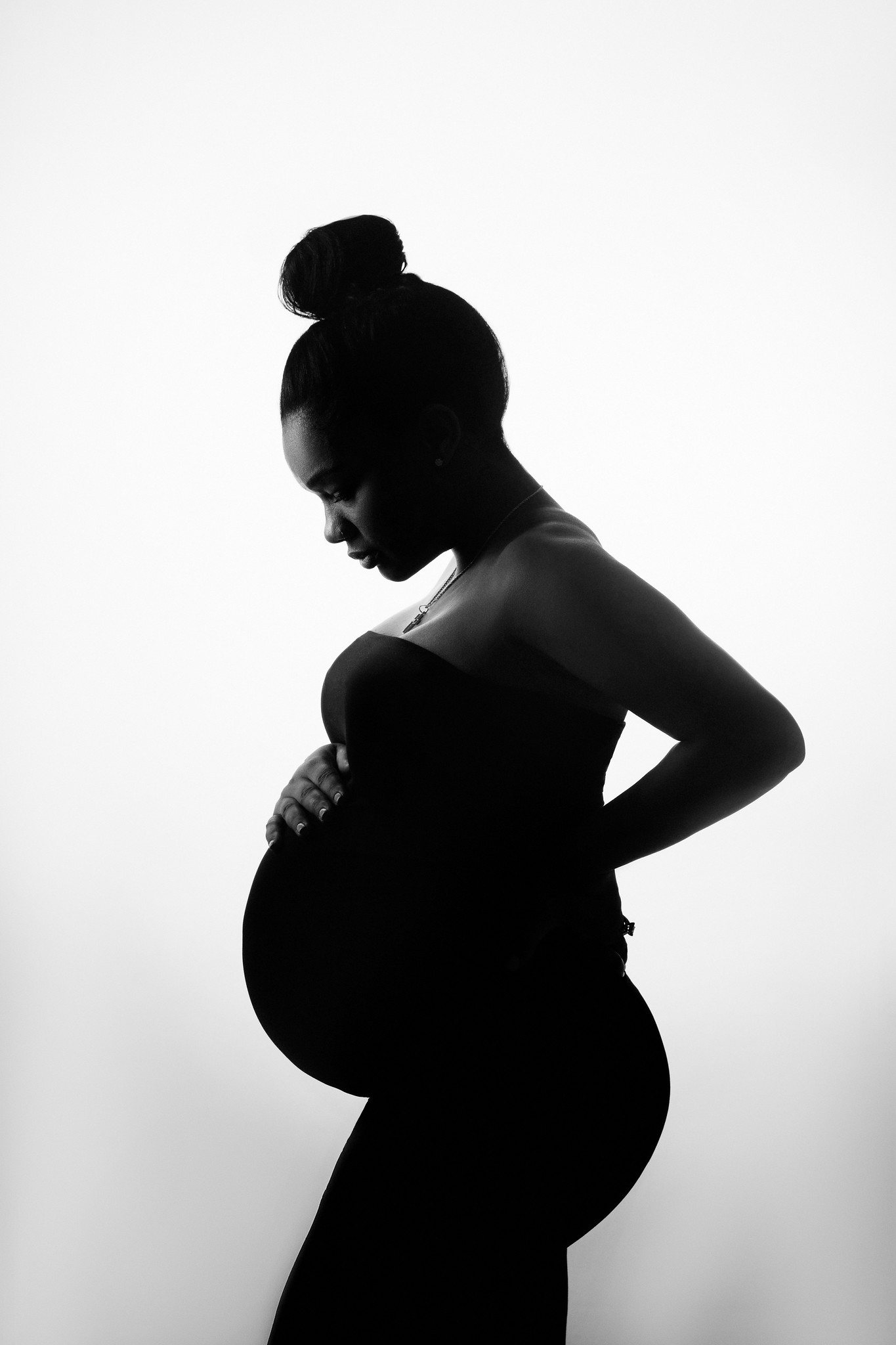 black and white silhouette photo of pregnant woman