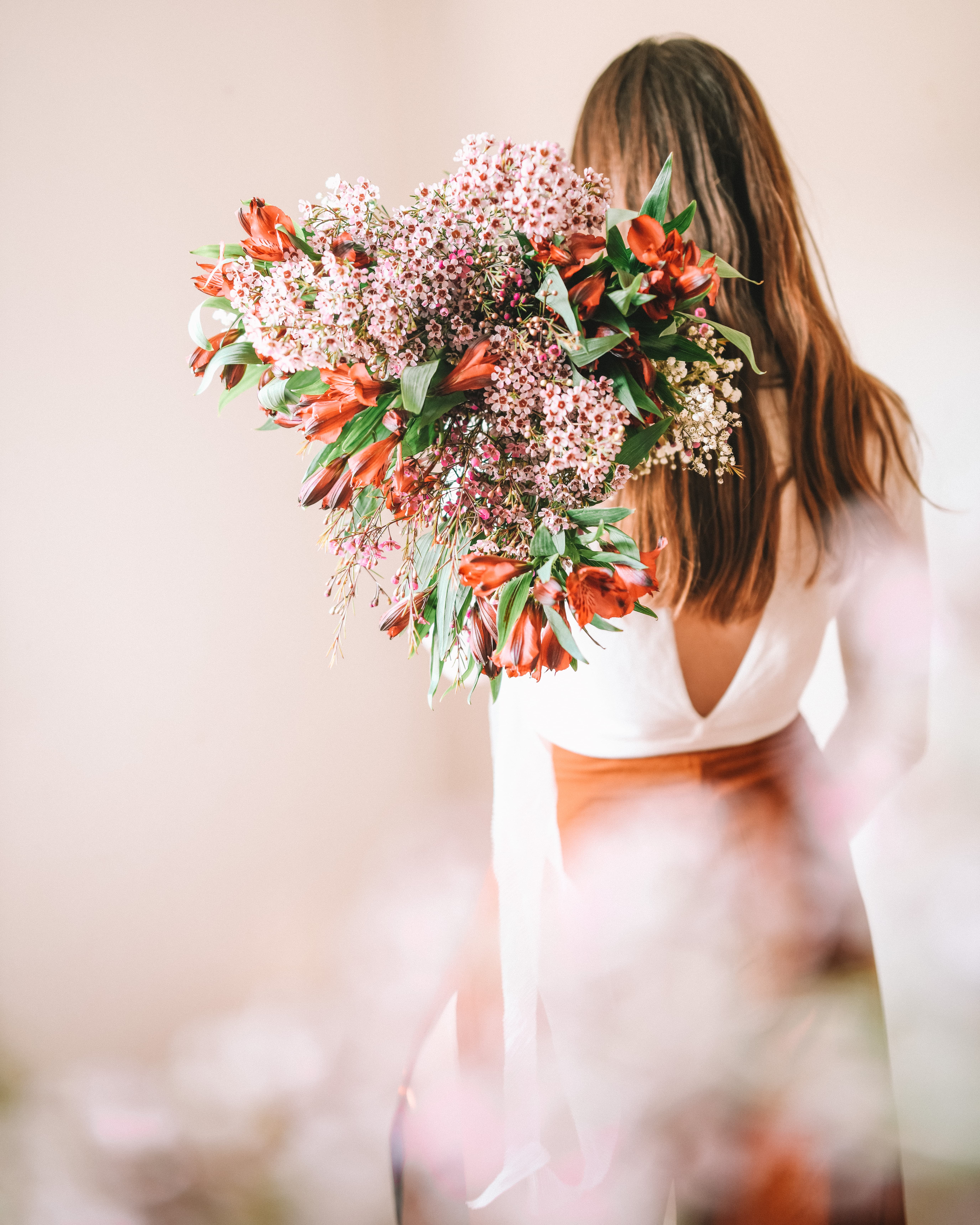 Girl with her back to the camera holding bouquet