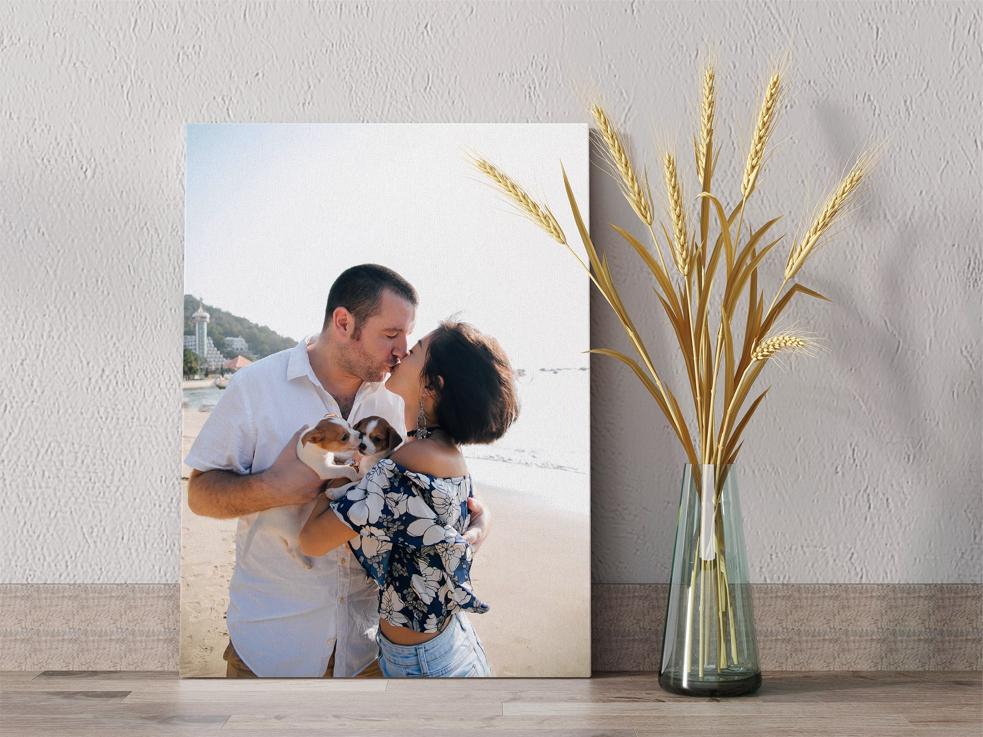 canvas decor of couple kissing with their dogs on the beach