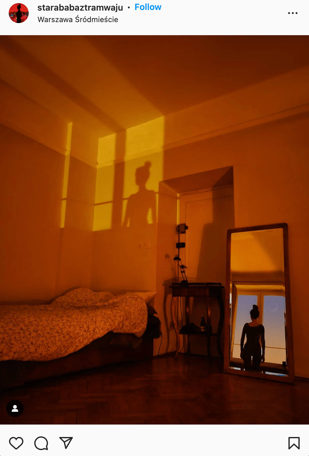 girl in a mirror looking outside window at sunset