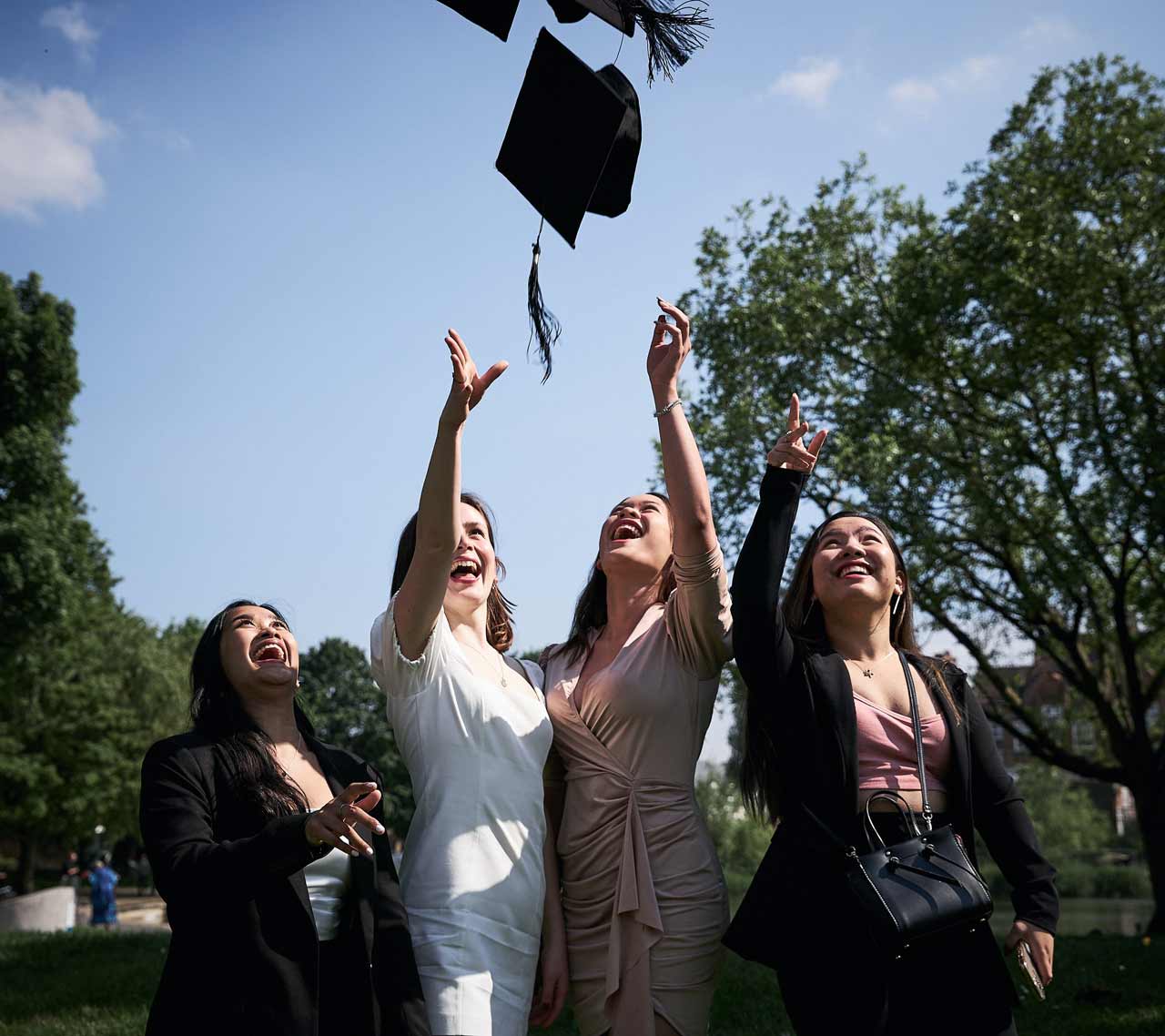 graduates throwing caps in the air