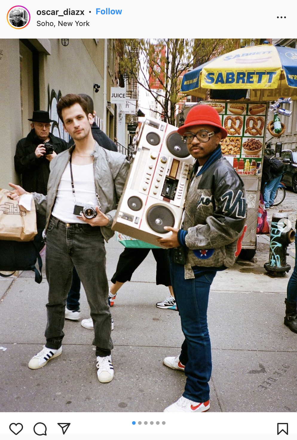 two men holding film camera and boombox in new york